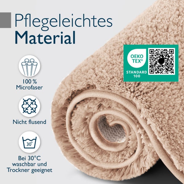 Aufgerollter Badteppich aus Mikrofaser mit Oeko Tex Standard 100 Zertifizierung, flusenfrei, waschbar bei 30 Grad und trocknergeeignet.