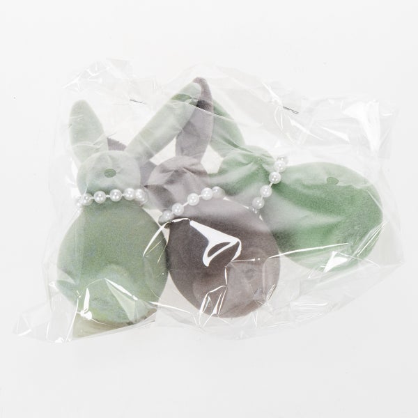 Dekorative Hasenfiguren mit Perlenhalsband in Verpackung