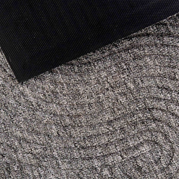 Detailansicht eines strukturierten Teppichs mit dunkler Rückseite.