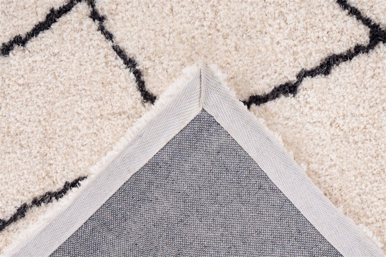 Hochflor-Teppich mit geometrischem Linienmuster und Detailansicht der gewebten Rückseite.