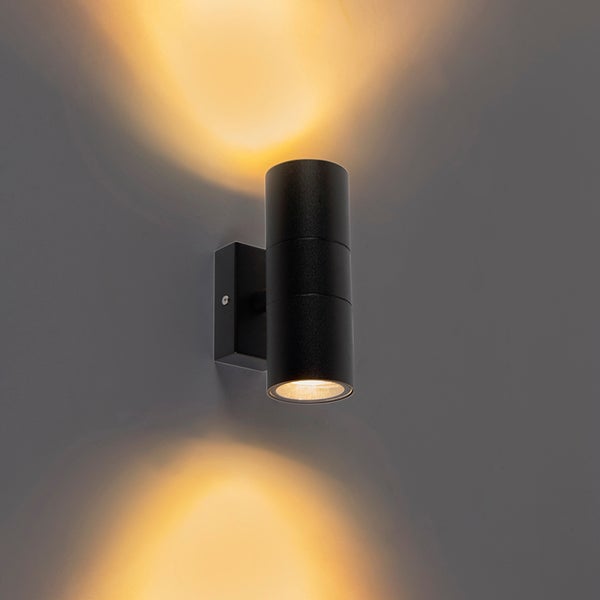 Schwarze zylindrische Außenwandleuchte mit Up- und Downlight Lichteffekt für eine dekorative Wandbeleuchtung.