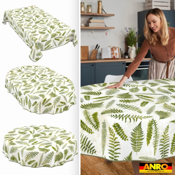 Tischdecke mit Farn-Muster in rechteckiger, ovaler und runder Form. Eine Frau breitet die Decke auf einem Tisch in einer hellen Küche aus. ANRO Logo.