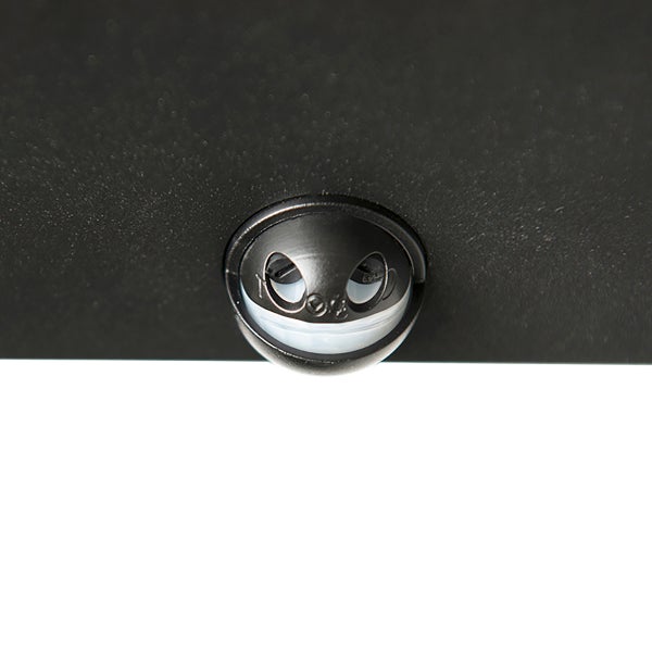 Nahaufnahme eines runden Bewegungssensors aus schwarzem Kunststoff, eingebaut in ein strukturiertes Gehäuse.