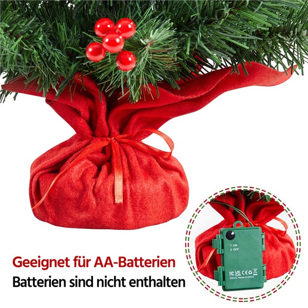 Detailaufnahme eines künstlichen Weihnachtsbaums mit rotem Stofffuß und Beeren