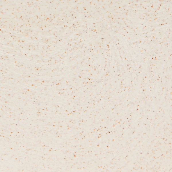 Nahaufnahme einer hellen Oberfläche mit braunen Sprenkeln