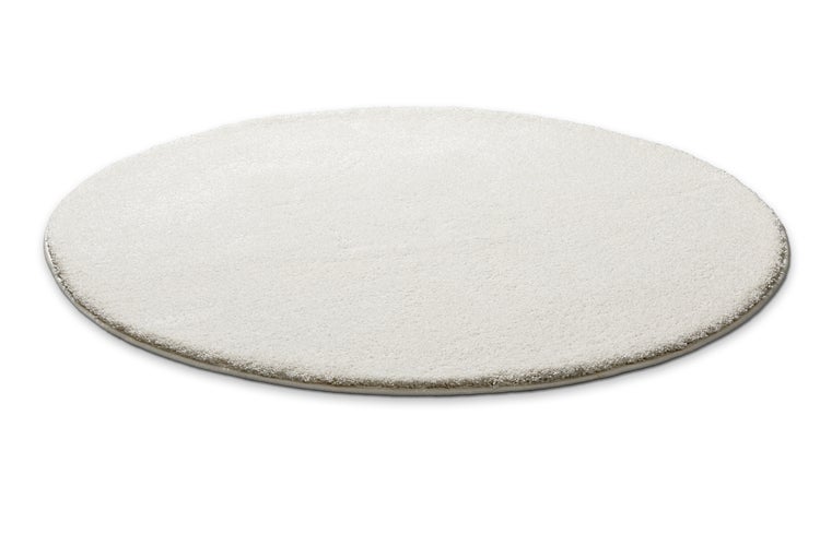 Runder weißer Hochflor-Teppich mit weicher Struktur.