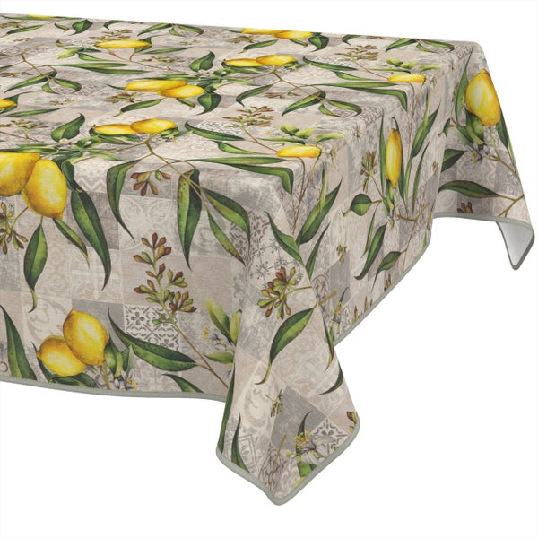 Tischdecke mit Zitronen- und Blättermuster auf einem Patchwork-Hintergrund aus ornamentalen Kacheln.