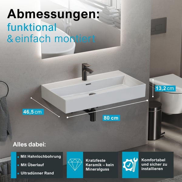 Modernes Badezimmer mit weißem Keramik-Wandwaschbecken, Maße 80 mal 46,5 mal 13,2 Zentimeter, inklusive schwarzer Armatur und Siphon.