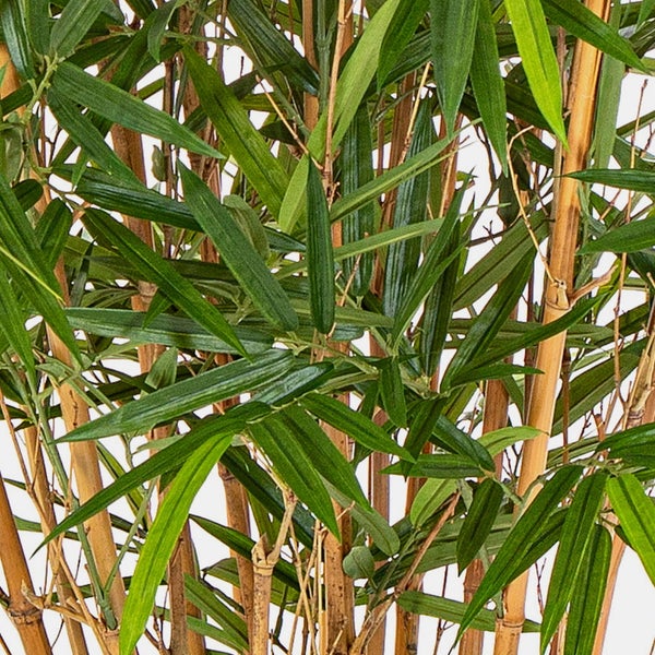 Künstliche Bambuspflanze mit naturgetreuen Halmen und grünen Blättern in einem schwarzen Topf.