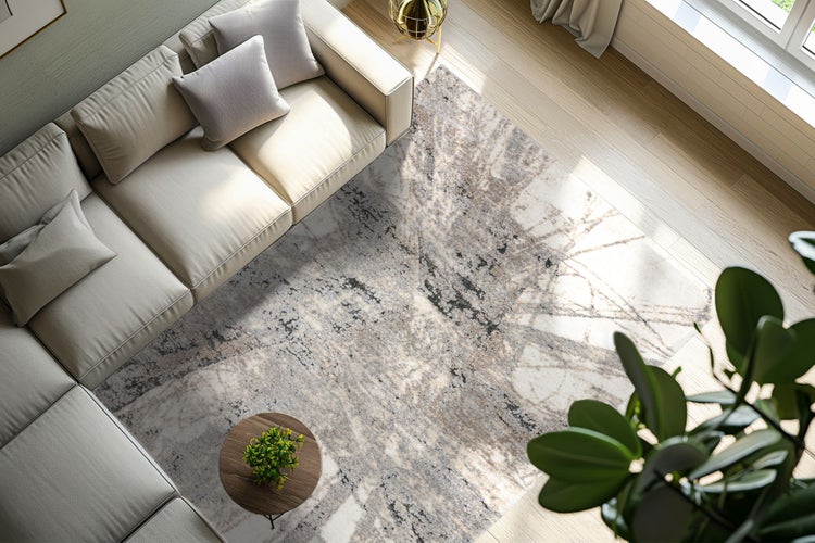 Wohnzimmer mit Sofa, Holzboden und einem großflächigen Teppich mit abstraktem Muster in einer hellen und modernen Wohnumgebung.