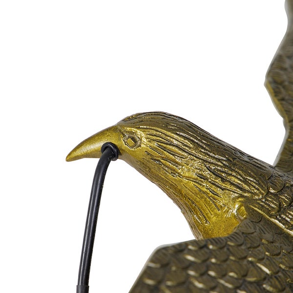 Adlerfigur mit Stromkabel im Schnabel