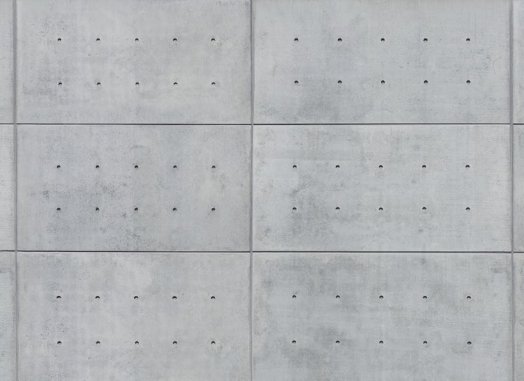 Wandpaneele in Sichtbeton-Optik mit charakteristischen Ankerlöchern und sichtbaren Fugen.