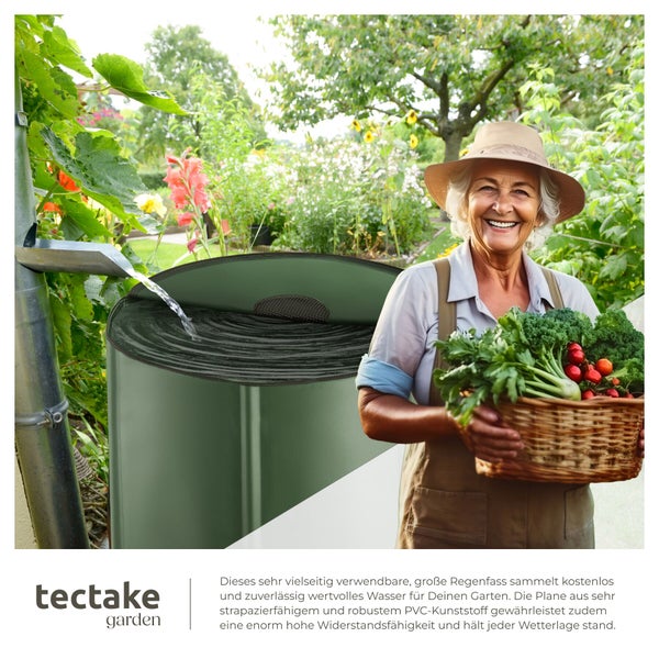 Eine Frau mit einem Korb voll Gemüse im Garten neben einem aufgestellten, mit Regenwasser gefüllten Regenfass aus robustem PVC Kunststoff.
