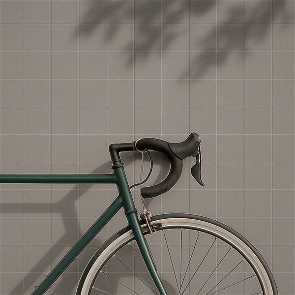 Quadratische Wandfliesen in einem Wohnraum mit einem Rennrad im Vordergrund.