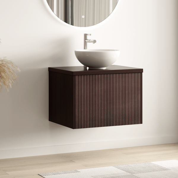 Modernes, helles Badezimmer mit wandhängendem Waschbeckenunterschrank in dunkler Holzoptik, geriffelter Front, weißem Aufsatzwaschbecken und Spiegel.