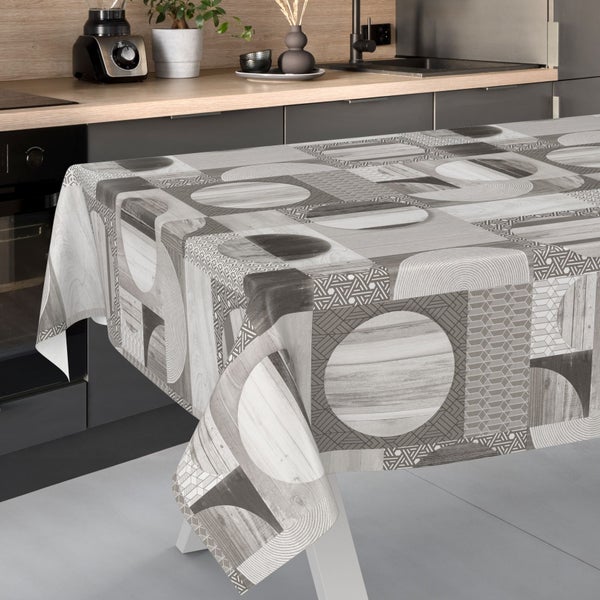 Abwaschbare Tischdecke mit geometrischem Muster aus Kreisen und Holzoptik in einer modern gestalteten Küche auf einem Esstisch.