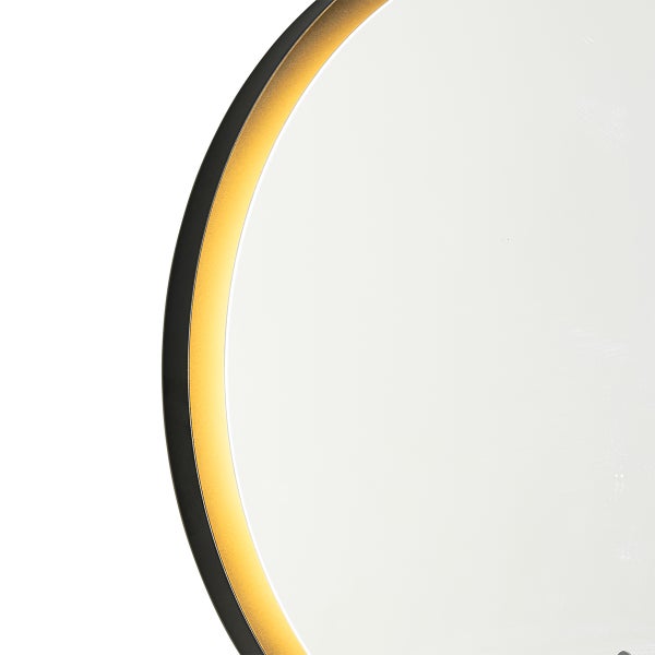 Detailansicht eines runden Spiegels mit schwarzem und goldenem Rahmen