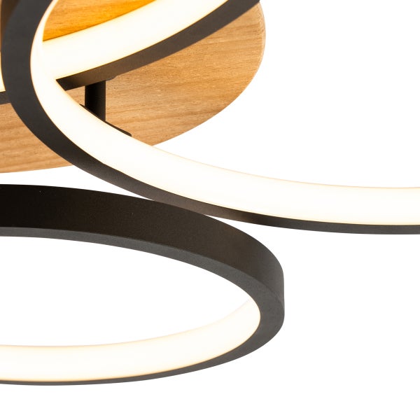 Moderne LED Deckenleuchte mit geschwungenen Lichtelementen und Holzelementen