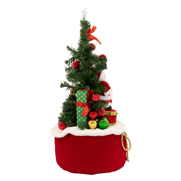 Geschmückter künstlicher Weihnachtsbaum in einem weihnachtlichen Geschenkesack stehend