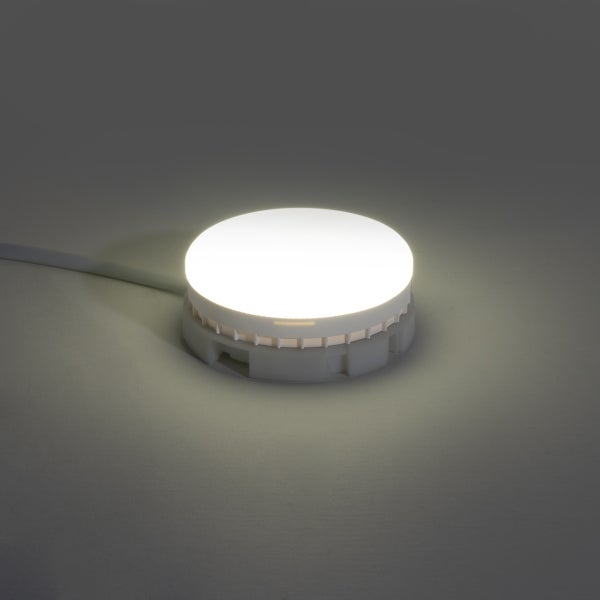 Runde, leuchtende LED-Unterbauleuchte in Weiß mit Stromkabel.