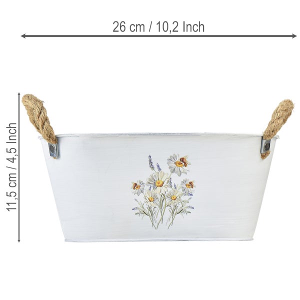 Weißer Metall-Pflanztopf mit Seilgriffen und Blumenmotiv, Breite 26 Zentimeter, Höhe 11,5 Zentimeter.