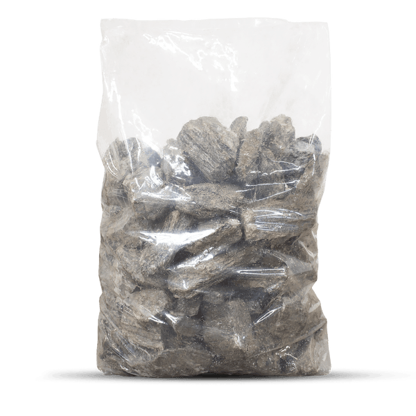 Graue Bruchsteine in einem transparenten Kunststoffsack.
