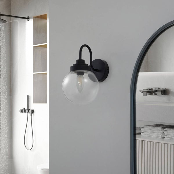 Badezimmer mit Dusche, Spiegel und Wandleuchte mit Glaskugel