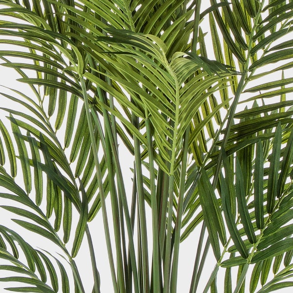 Künstliche Palme im schwarzen Topf mit grünen Wedeln und naturgetreuen Stielen.