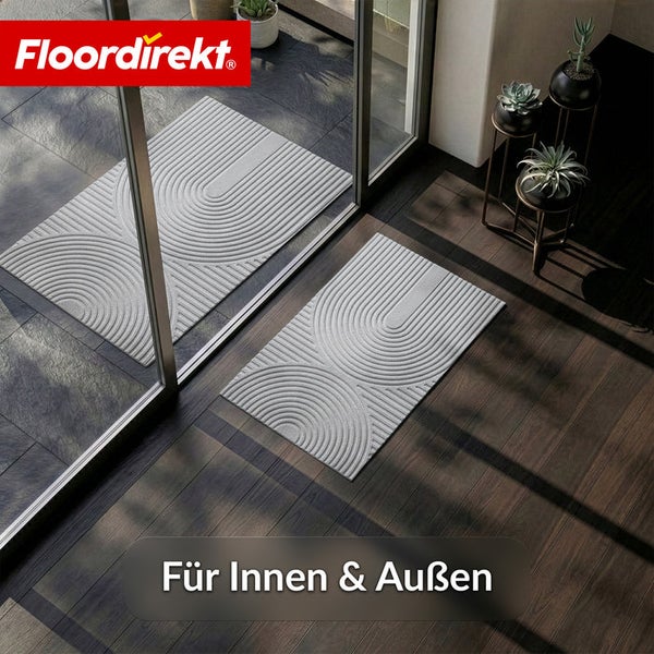 Floordirekt Logo. Schmutzfangmatte mit Bogenmuster vor und hinter einer Glastür für den Innenbereich und Außenbereich in hellem Eingangsbereich.