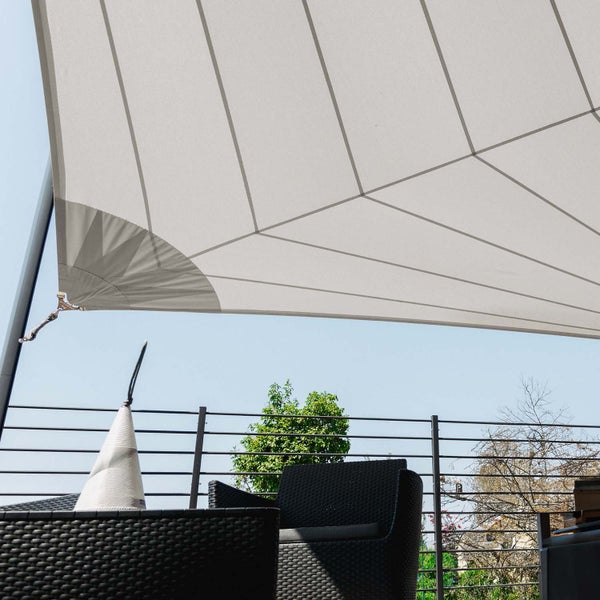 Sonnensegel über einer Terrasse mit schwarzen Gartenmöbeln und Metallgeländer.