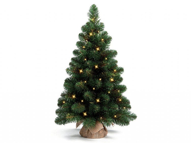 Künstlicher Weihnachtsbaum mit LED Beleuchtung und Jutesack als Fuß.
