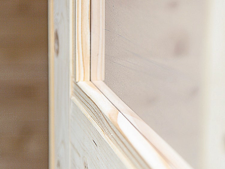 Detailansicht eines Holzrahmens mit Glaseinsatz einer Innentür aus Nadelholz.