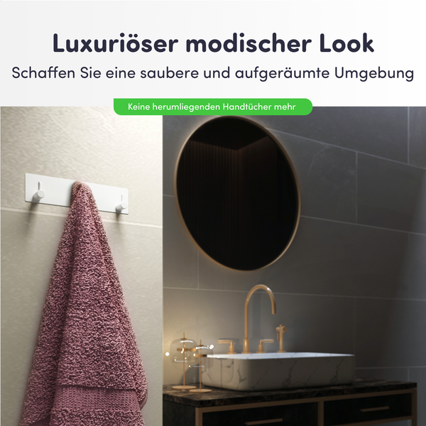 Modernes Badezimmer mit weißer Hakenleiste, rosa Handtuch, Waschbecken mit goldener Armatur und rundem Spiegel.