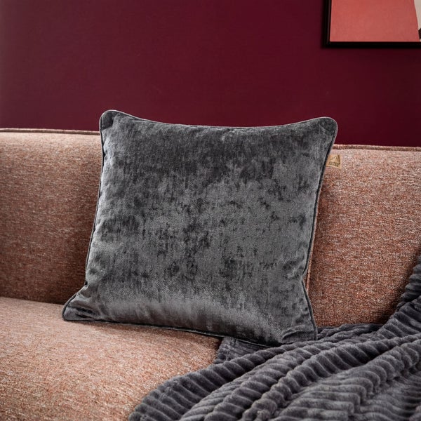 Dekokissen aus Samt auf einem Sofa mit einer Decke