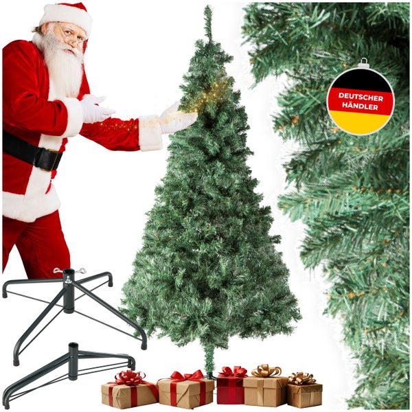 Künstlicher Weihnachtsbaum mit Ständer, Geschenken und Dekoration. In der Szene ist ein Weihnachtsmann zu sehen. Deutscher Händler.