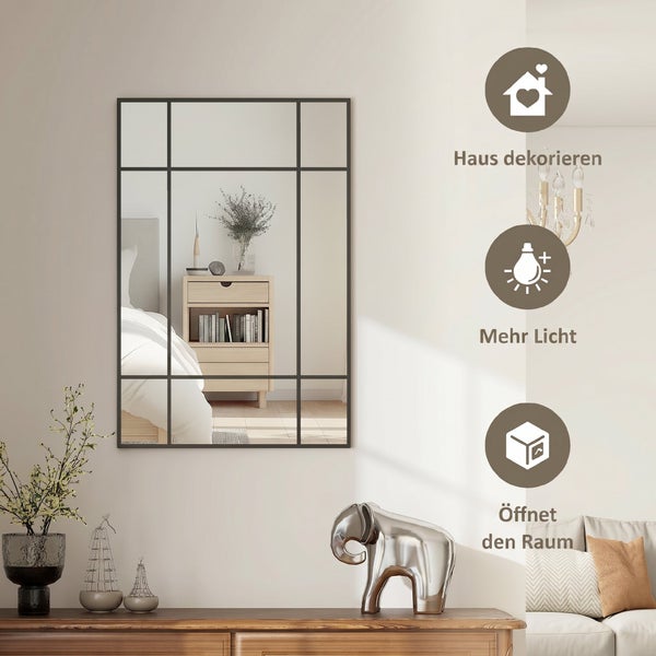 Rechteckiger Wandspiegel im Sprossenfenster-Design mit schwarzem Rahmen in hellem Zimmer. Symbole für Deko, mehr Licht und Raumvergrößerung.