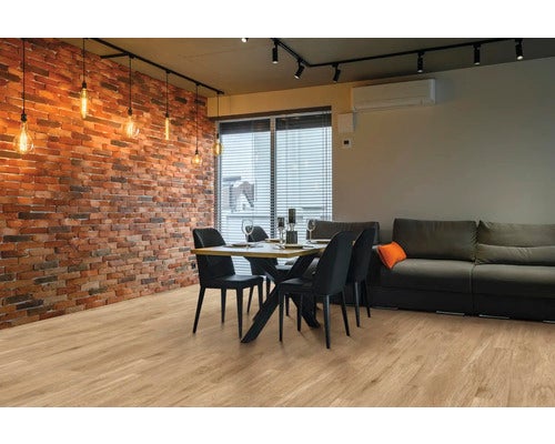 Wohnzimmer mit Esstisch, Stühlen, Sofa, Ziegelwand und Beleuchtung