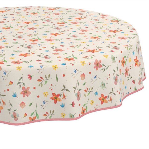 Runde Tischdecke mit buntem Blumenmuster und rosa Wellenrand.