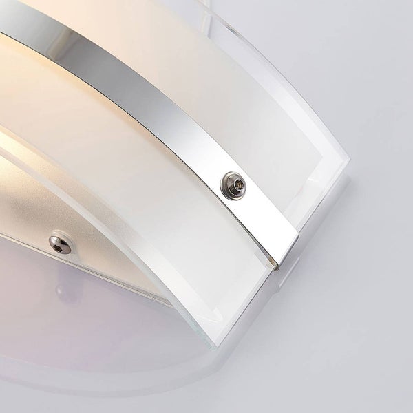 Detailansicht einer Wandleuchte mit gebogenem Glas und einem Metallstreifen aus glänzendem Chrom.