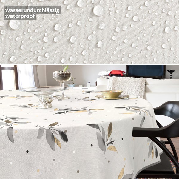 Wasserdichte, runde Tischdecke mit Blattmuster und Punkten in einem hellen Wohnzimmer; Detailansicht zeigt Wassertropfen auf dem Stoff.