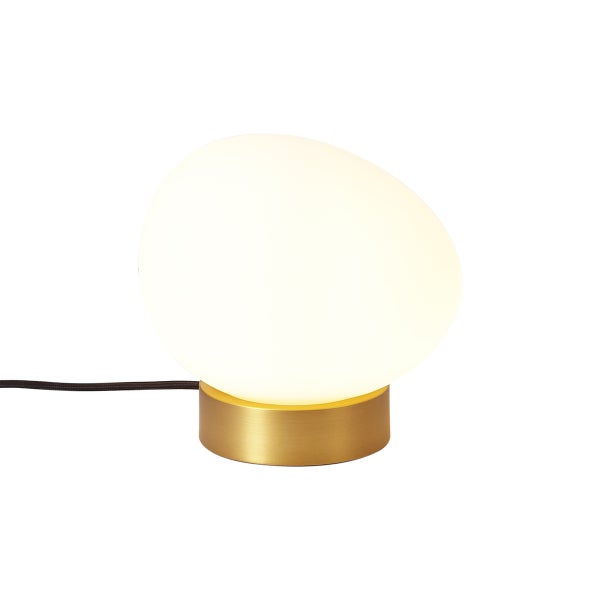 Moderne Tischleuchte mit asymmetrischem Schirm aus weißem Glas und einem zylindrischen Metallsockel in Messingoptik.