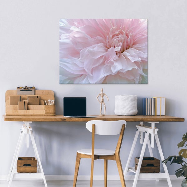 Wandbild mit einer Nahaufnahme einer Blüte über einem organisierten Schreibtisch mit Laptop, Holzelementen, Büchern und einem Stuhl.