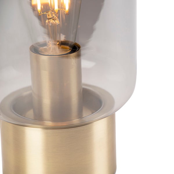 Nahaufnahme einer Tischleuchte mit klarem Glasschirm und einer Glühbirne