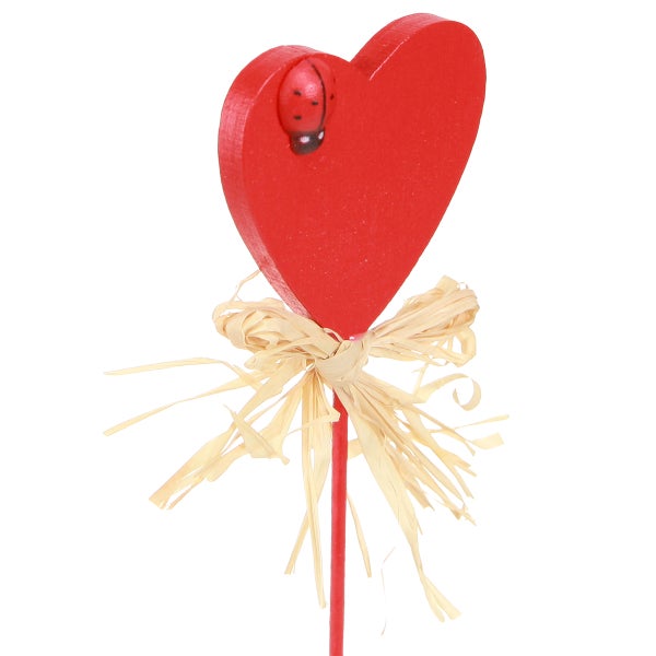 Dekorativer Herzstecker mit Marienkäfer und Schleife als Gartendekoration.