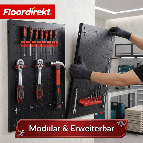Floordirekt Logo. Modulare und erweiterbare Werkzeuglochwand aus schwarzem Metall mit Hammer, Ratschen und Schraubendrehern in einer Werkstatt.