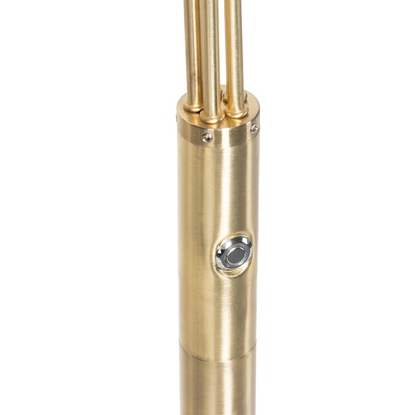 Detailaufnahme einer goldenen Stehlampe mit Schalter