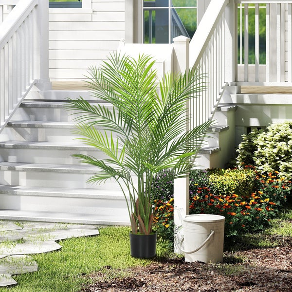 Szene im Freien mit einer künstlichen Palme im Topf vor einer Treppe.