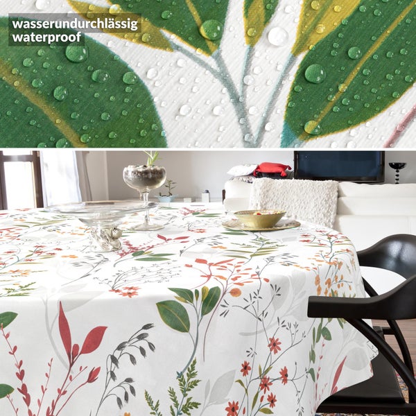 Wasserdichte Tischdecke mit floralem Muster auf einem runden Tisch in einem hellen Wohnzimmer.