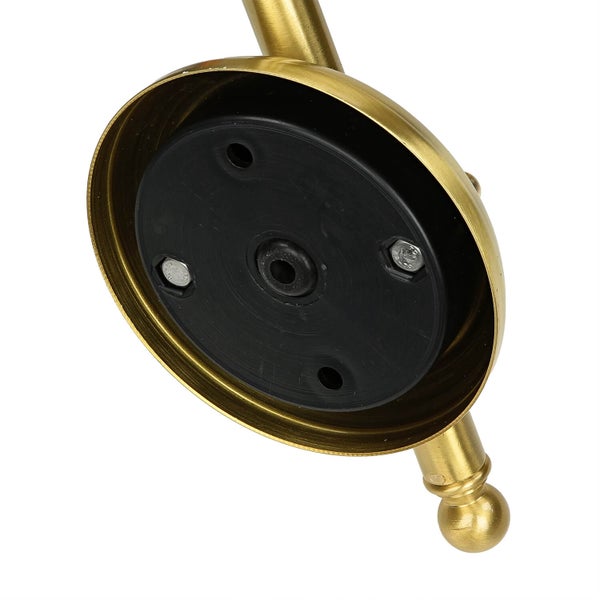 Detailansicht einer goldenen Lampenhalterung mit schwarzer Kunststoffbefestigung