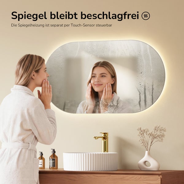 Ovaler LED-Badspiegel mit Antibeschlagfunktion und Touch-Steuerung, abgebildet in einem Badezimmer mit einer Frau am Waschbecken.
